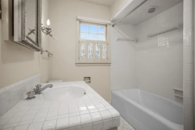 a bathroom with a bathtub and a shower