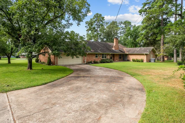 a house with huge green field in front of it