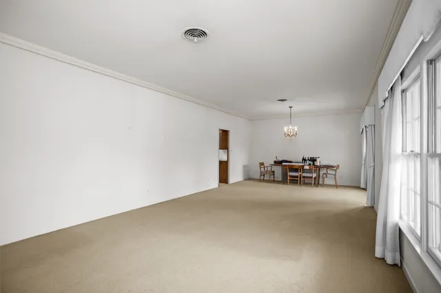 a view of a livingroom with furniture and floor to ceiling window