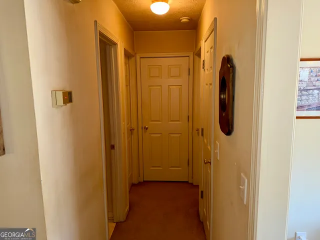 a kitchen with stainless steel appliances granite countertop a sink dishwasher and a refrigerator with wooden floor