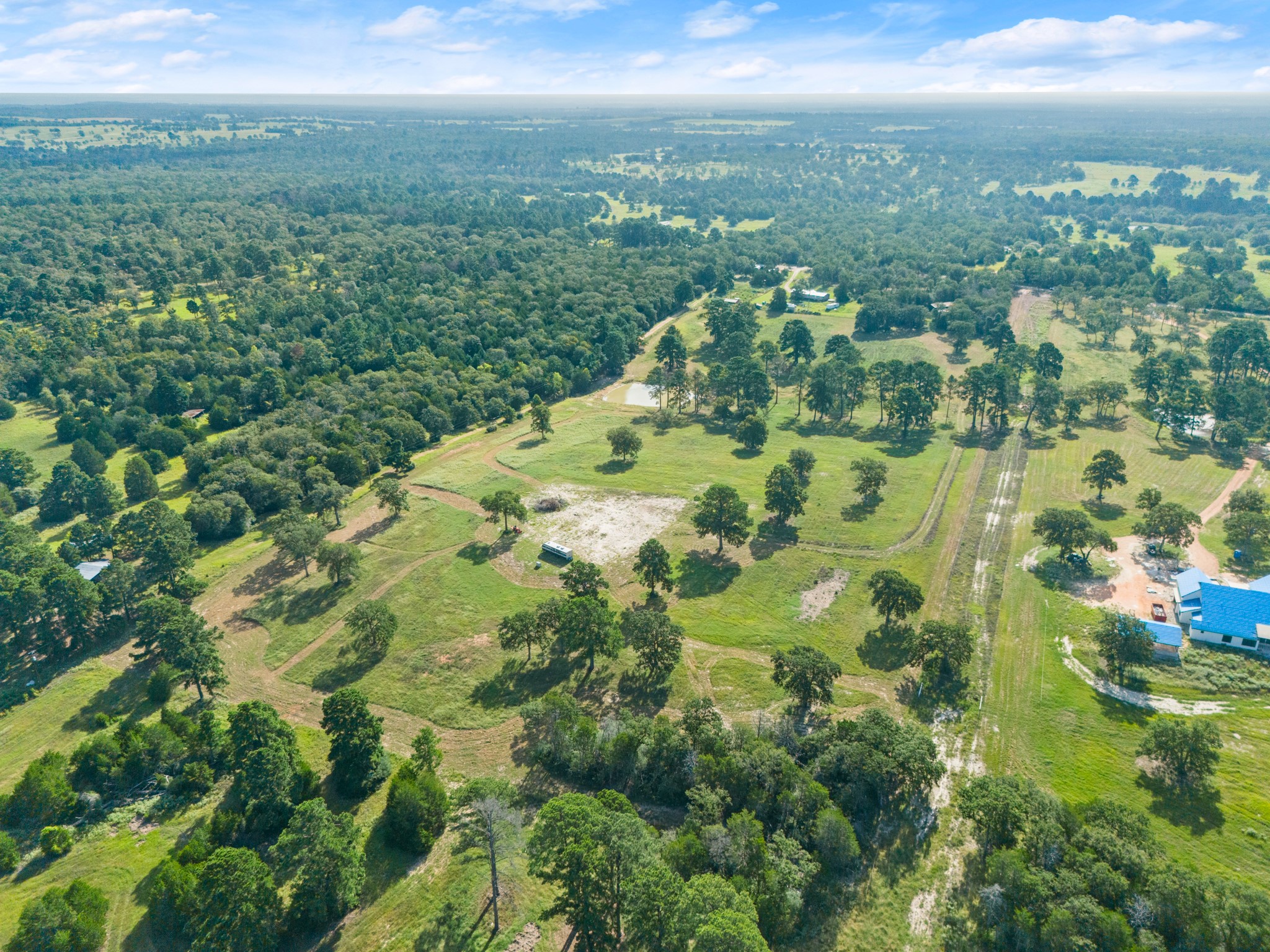 170 Split Oak Road Smithville, TX 78957 - Photo 23 of 31 Sprawling natural landscape with a blend of wooded areas and open grassy fields awaits your vision.