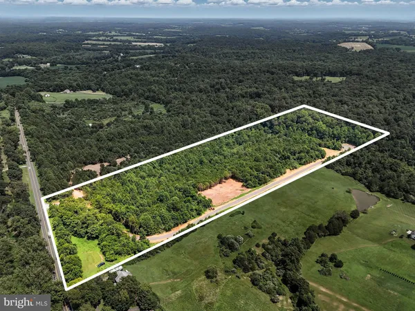a view of a yard with wooden fence