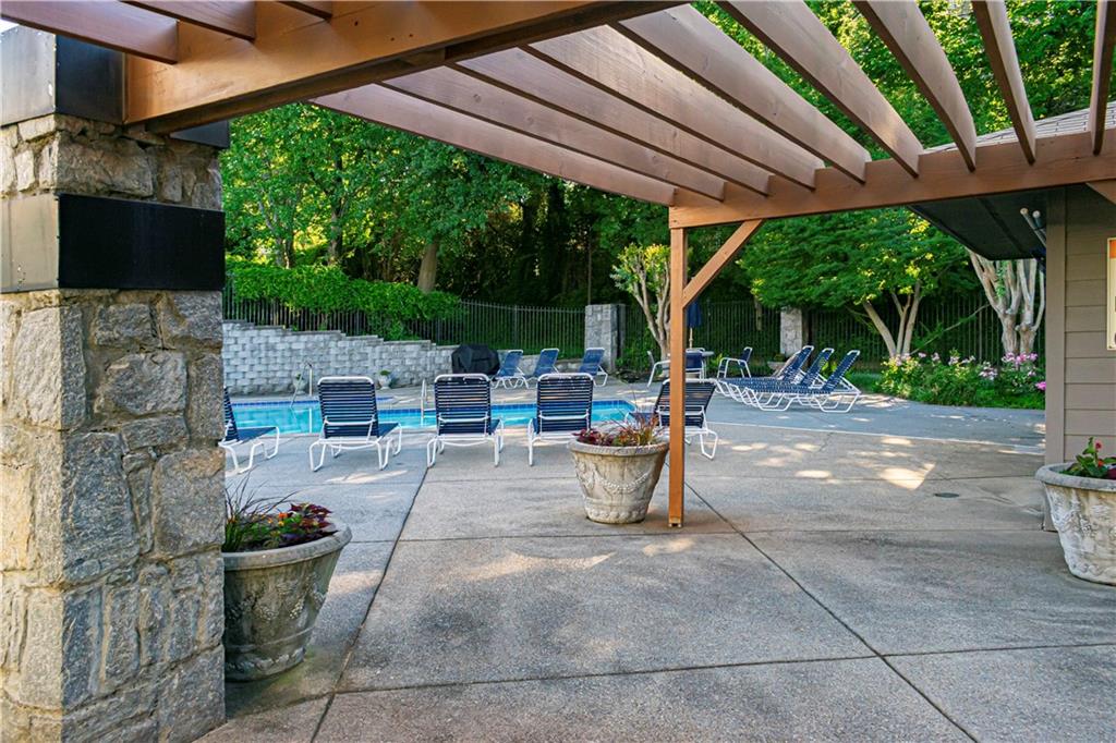 19 Finch Trail Northeast Atlanta, GA 30308 - Photo 24 of 28 a view of a patio with chairs and couches under an umbrella