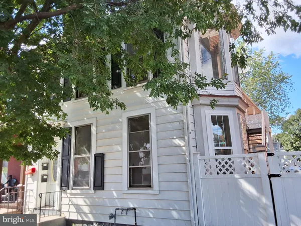 front view of a house with a tree