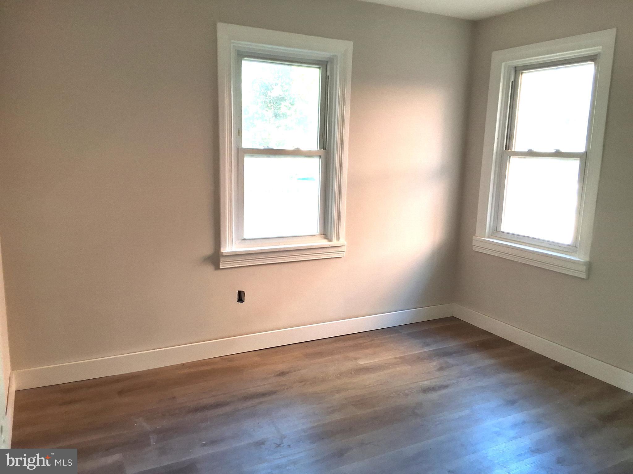 1015 Chestnut Street, Unit 1 Lebanon, PA 17042 - Photo 13 of 16 an empty room with wooden floor and windows