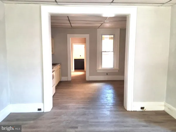 a view of a room with wooden floor and window