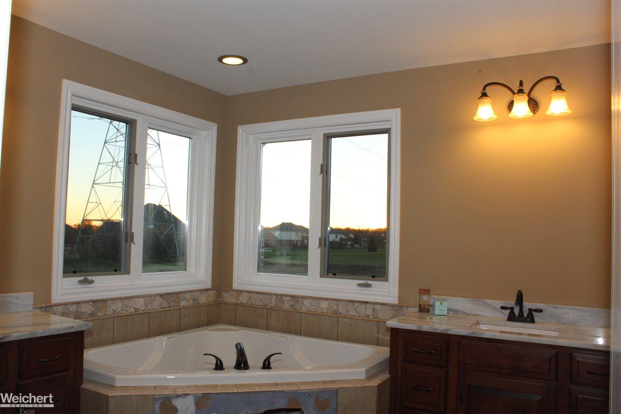 8812 Ridge Drive Washington, MI 48095 - Photo 36 of 44 Double Vanity/Sinks, Spa Tub, Shower and Private Toilet Room, Tile Floors and Tile Walls and Ceiling in Shower + Euro Glass Doors included & Large Mirrors over Vanities