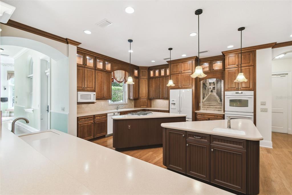 1745 Taylor Woods Road DeLand, FL 32724 - Photo 16 of 66 a large kitchen with kitchen island a large counter space a sink stainless steel appliances and cabinets