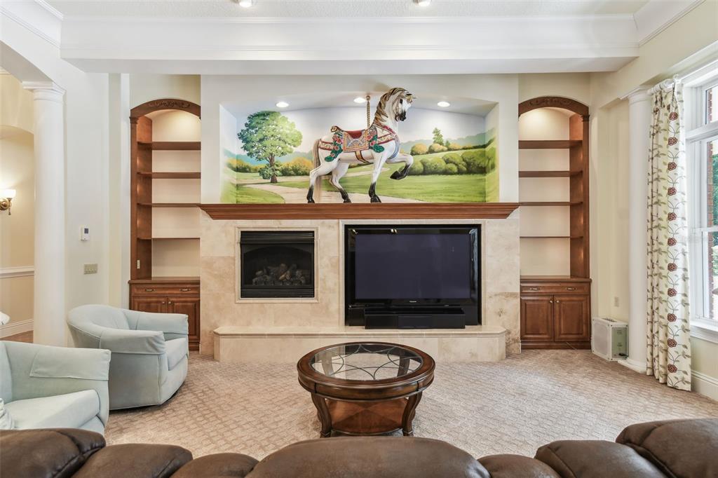 1745 Taylor Woods Road DeLand, FL 32724 - Photo 19 of 66 a living room with furniture a fireplace and a flat screen tv