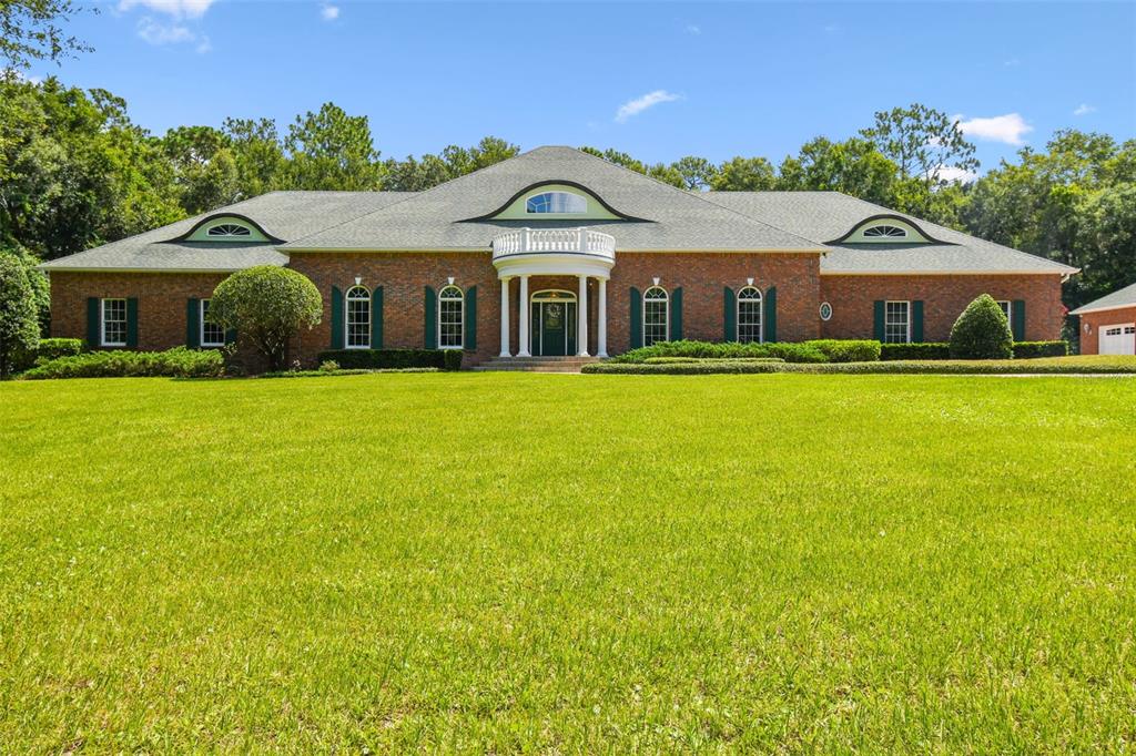 1745 Taylor Woods Road DeLand, FL 32724 - Photo 2 of 66 a front view of a house with garden