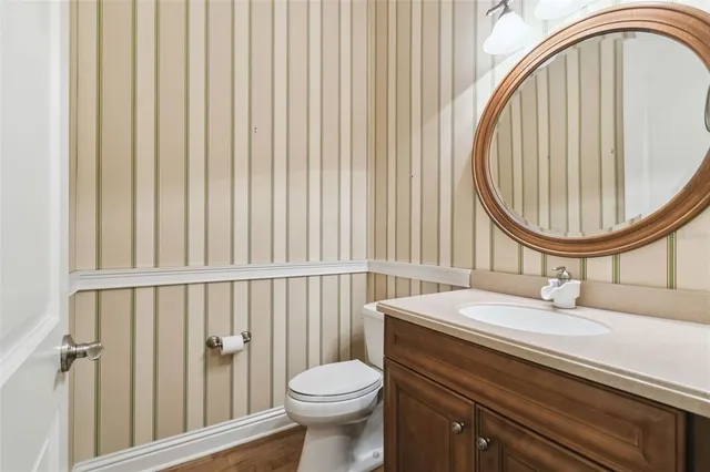 a spacious bedroom with a large bed and a chandelier