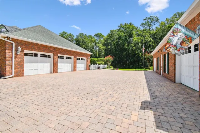 a front view of a house with a yard and trees