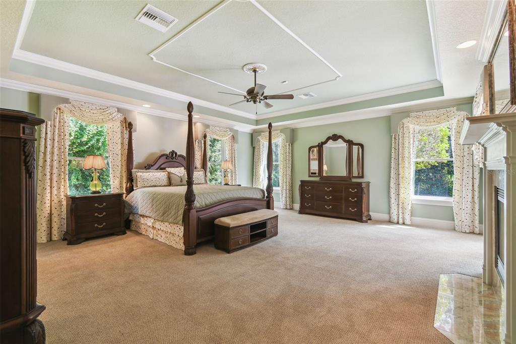 1745 Taylor Woods Road DeLand, FL 32724 - Photo 38 of 66 a spacious bedroom with a large bed and a chandelier