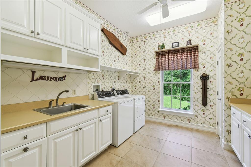 1745 Taylor Woods Road DeLand, FL 32724 - Photo 44 of 66 a kitchen with a sink and cabinets