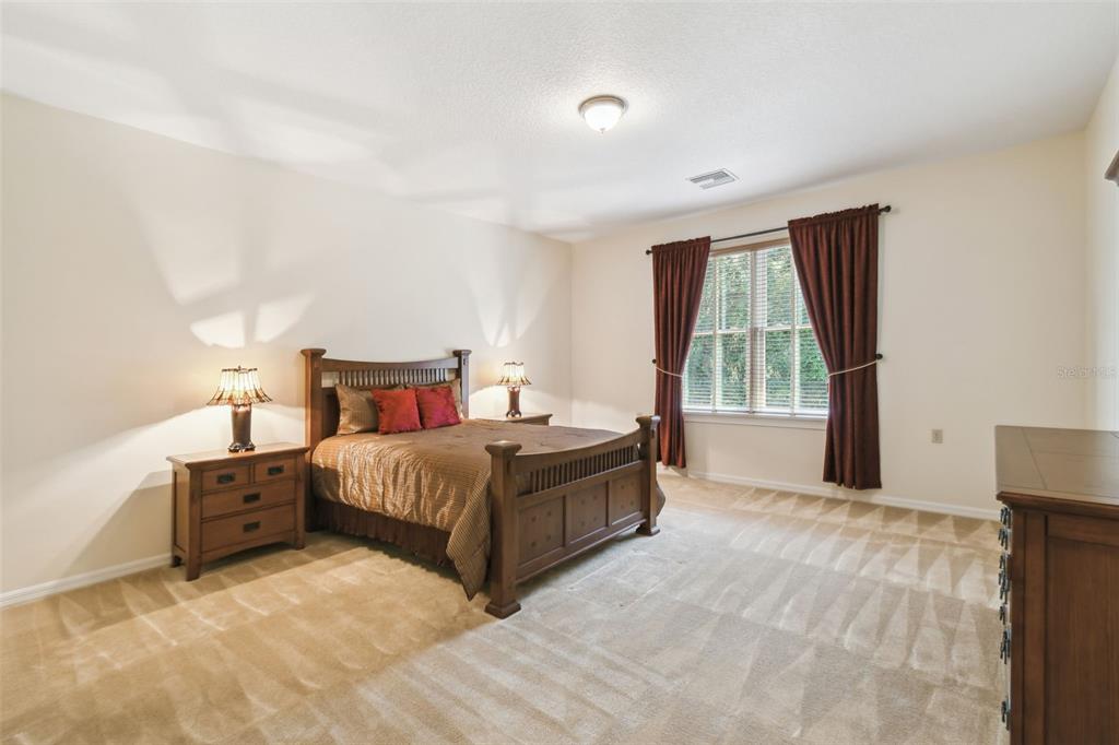 1745 Taylor Woods Road DeLand, FL 32724 - Photo 48 of 66 a spacious bedroom with a bed and a window