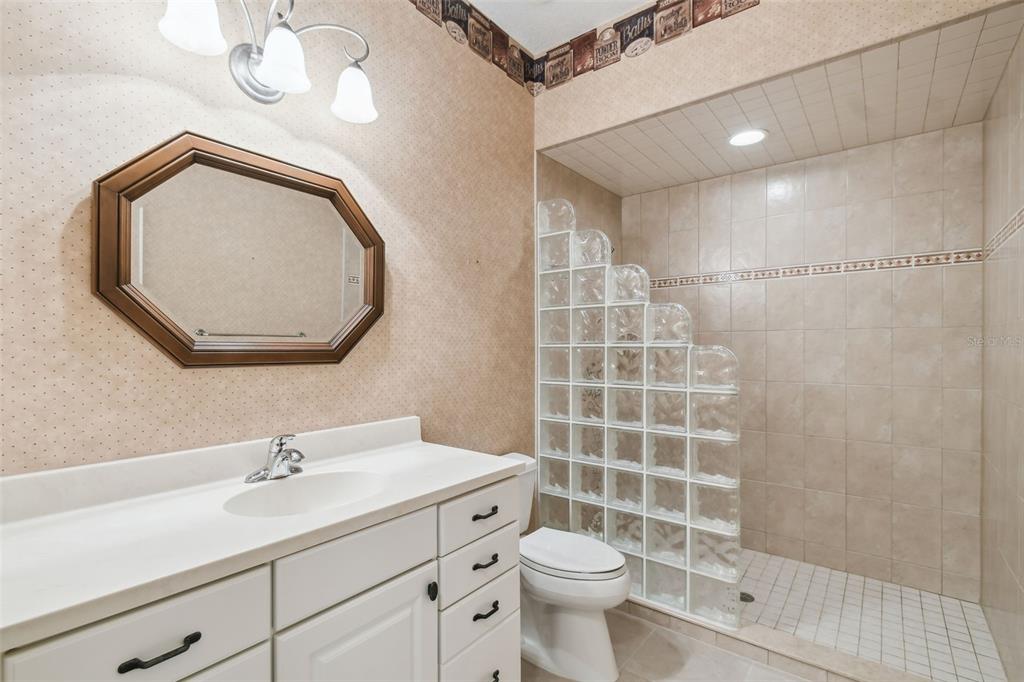 1745 Taylor Woods Road DeLand, FL 32724 - Photo 49 of 66 a bathroom with a sink a toilet and a mirror