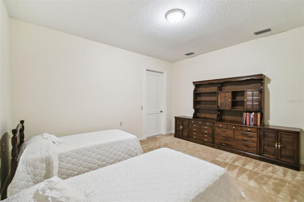 1745 Taylor Woods Road DeLand, FL 32724 - Photo 50 of 66 a bedroom with furniture and flat screen tv