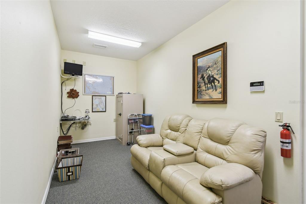 1745 Taylor Woods Road DeLand, FL 32724 - Photo 54 of 66 a living room with furniture and gym equipment