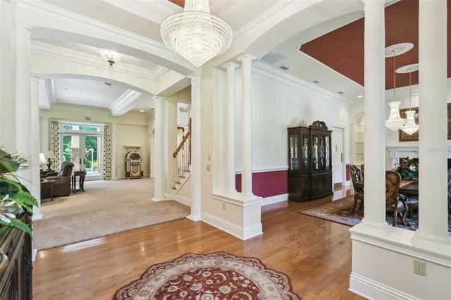 a dining room with furniture a fireplace and wooden floor