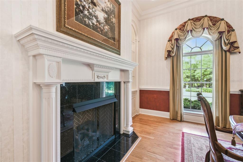 1745 Taylor Woods Road DeLand, FL 32724 - Photo 9 of 66 a living room with a fireplace and a large window
