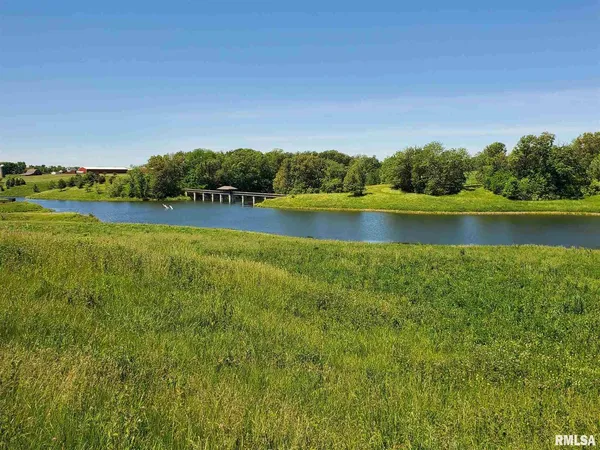 a view of a lake with houses in the back
