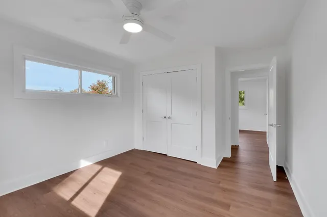 a view of a hallway with wooden floor