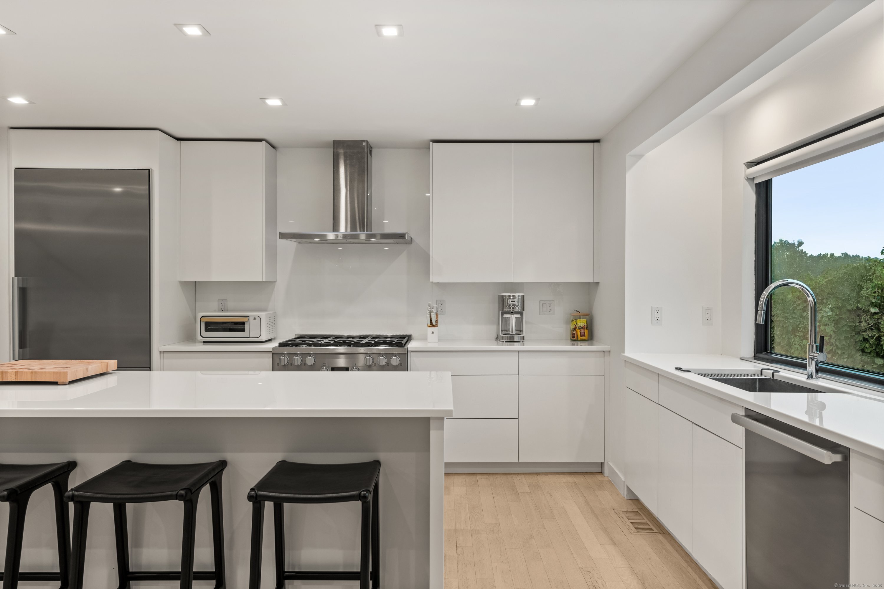 200 Hillspoint Road Westport, CT 06880 - Photo 12 of 37 a kitchen with stainless steel appliances granite countertop a sink and cabinets