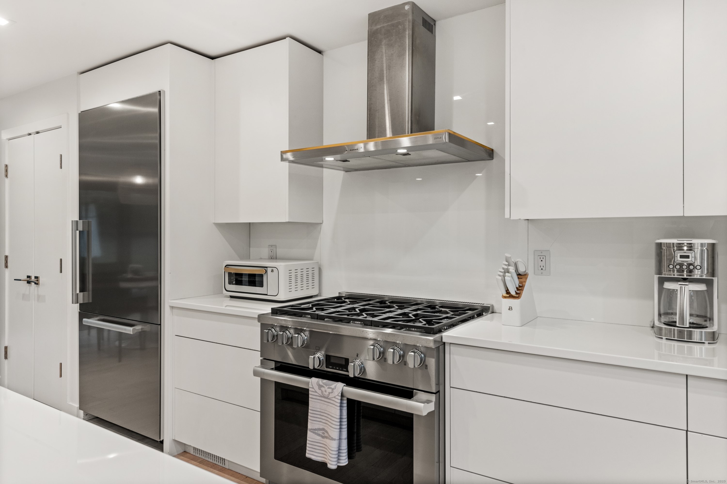 200 Hillspoint Road Westport, CT 06880 - Photo 15 of 37 a kitchen with stainless steel appliances a sink stove and refrigerator