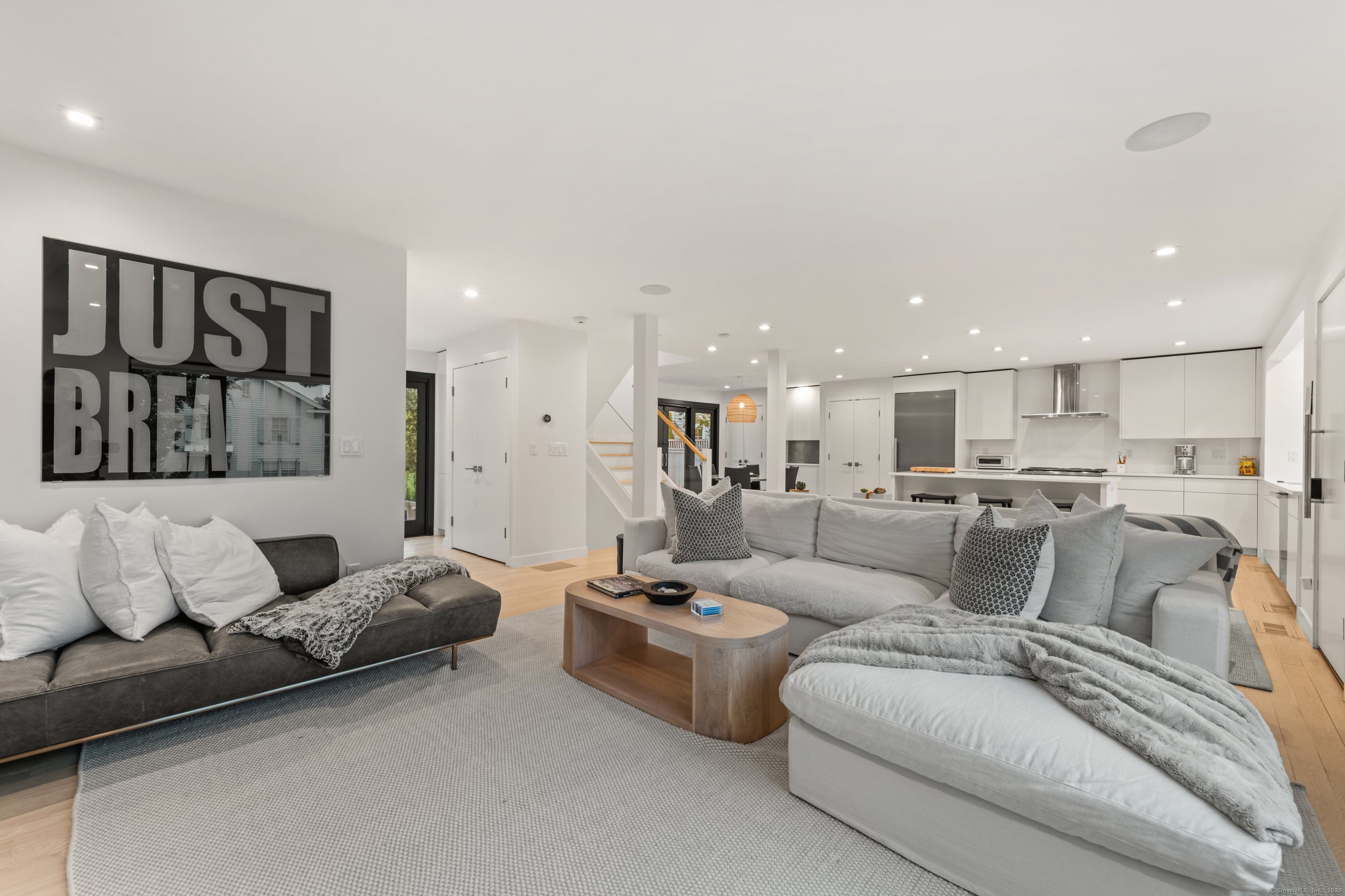 200 Hillspoint Road Westport, CT 06880 - Photo 6 of 37 a living room with furniture and a view of kitchen