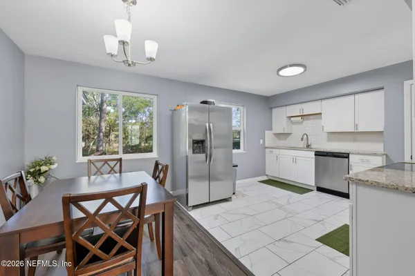 a view of a dining room with furniture window and wooden floor
