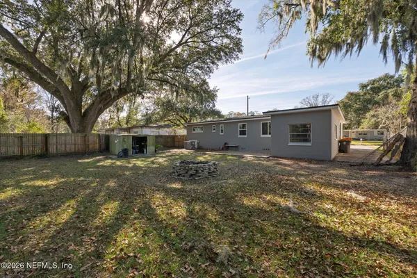 a view of a backyard with large trees
