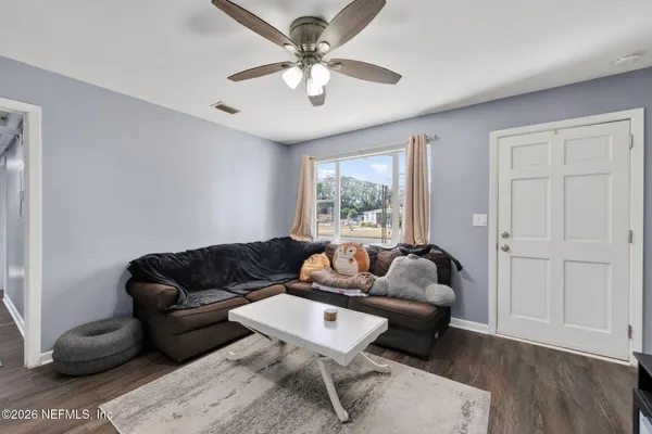 a living room with furniture and a flat screen tv