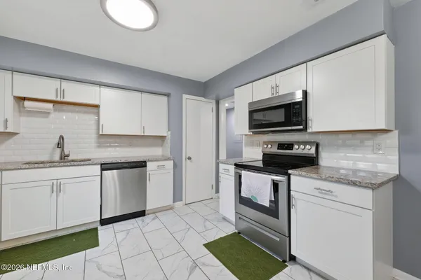 a view of a livingroom with furniture and window