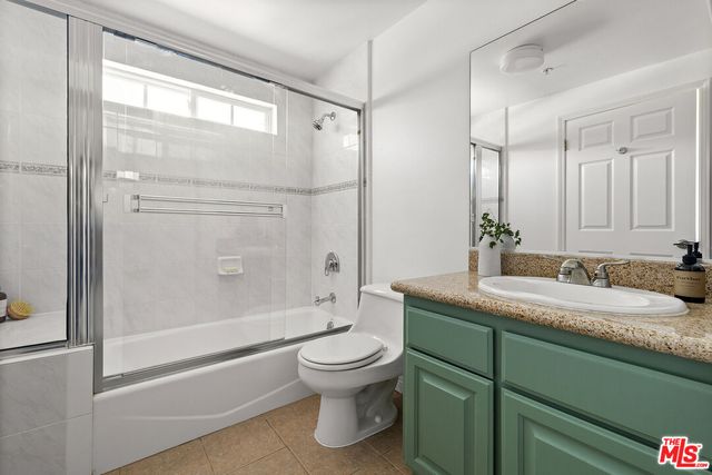 a bedroom with a bed and a mirror