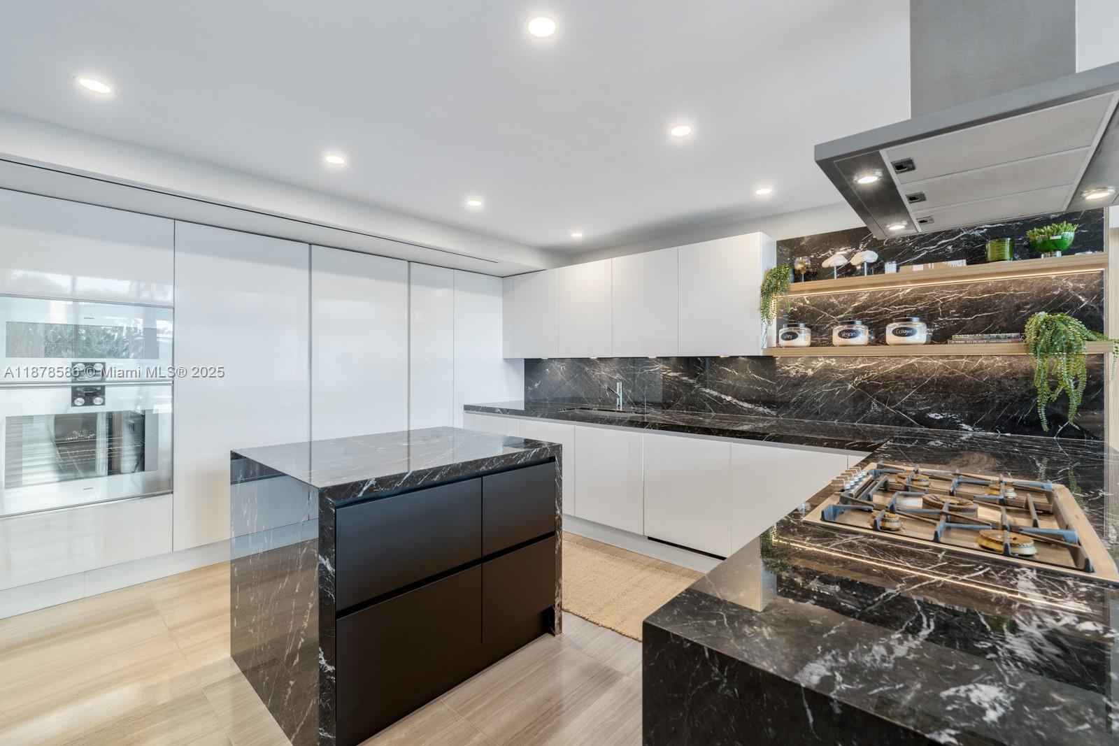 4701 Meridian Avenue, Unit 222 Miami Beach, FL 33140 - Photo 11 of 44 a kitchen with stainless steel appliances granite countertop a stove and a refrigerator