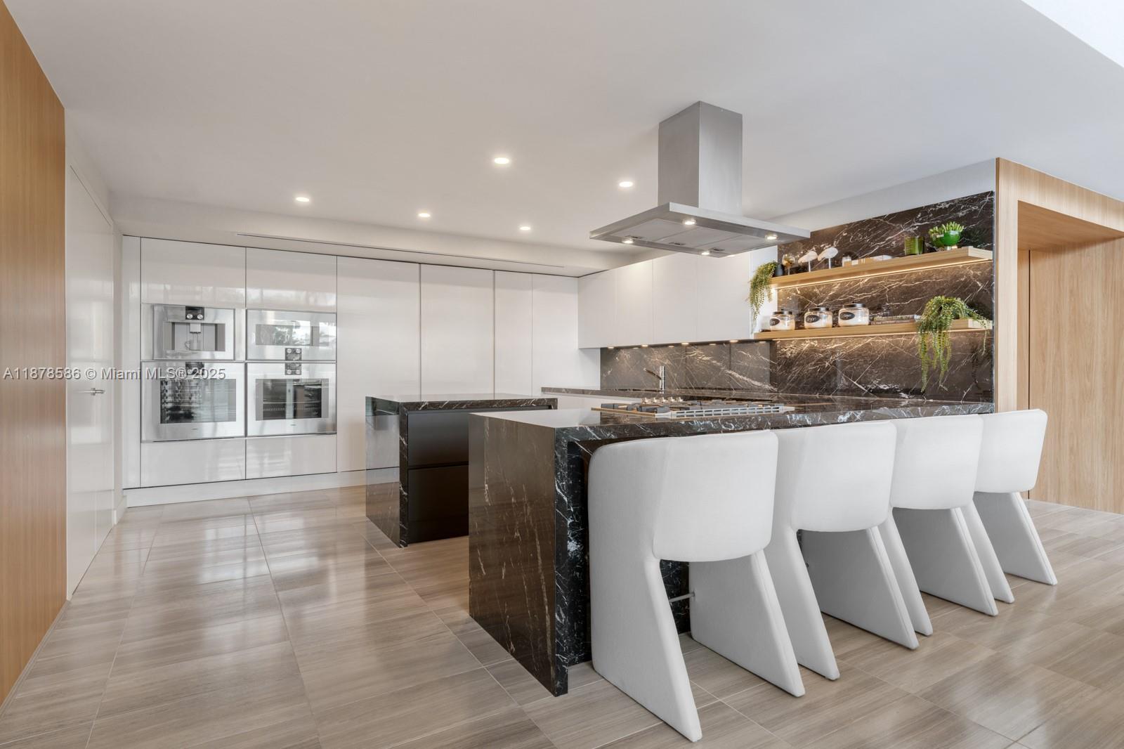 4701 Meridian Avenue, Unit 222 Miami Beach, FL 33140 - Photo 12 of 44 a kitchen with stainless steel appliances kitchen island granite countertop a sink and cabinets