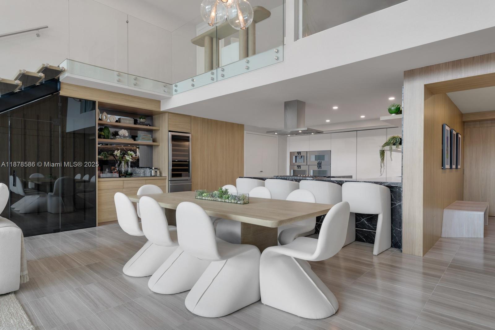 4701 Meridian Avenue, Unit 222 Miami Beach, FL 33140 - Photo 13 of 44 a large kitchen with a table and chairs