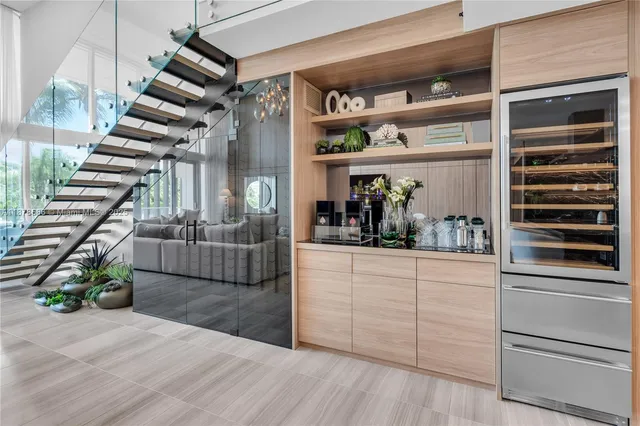 a kitchen with appliances cabinets and a potted plant