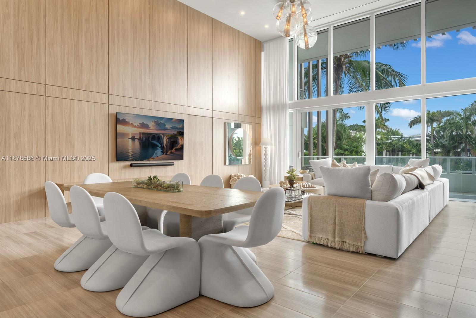 4701 Meridian Avenue, Unit 222 Miami Beach, FL 33140 - Photo 2 of 44 a living room with furniture a flat screen tv and floor to ceiling window