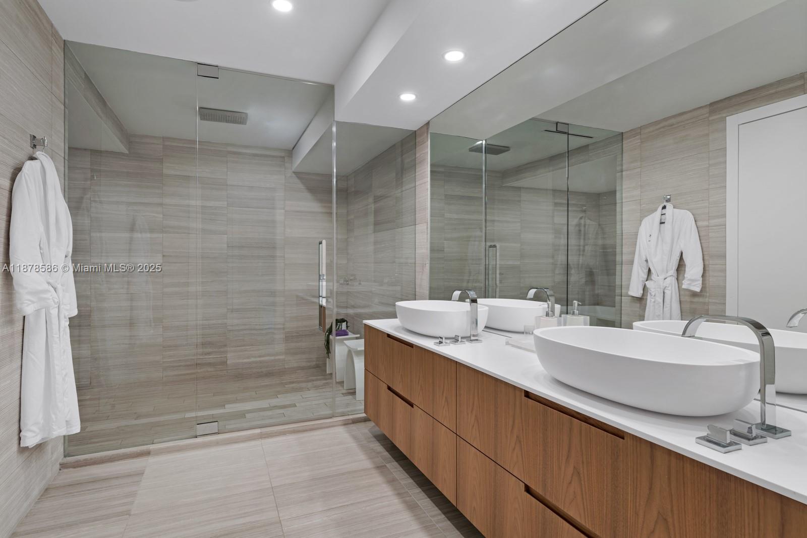 4701 Meridian Avenue, Unit 222 Miami Beach, FL 33140 - Photo 23 of 44 a bathroom with a double vanity sink mirror and shower