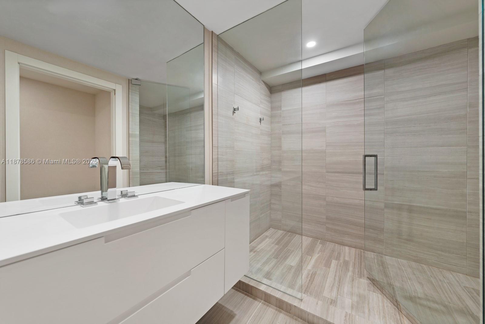 4701 Meridian Avenue, Unit 222 Miami Beach, FL 33140 - Photo 28 of 44 a bathroom with a sink shower and a mirror