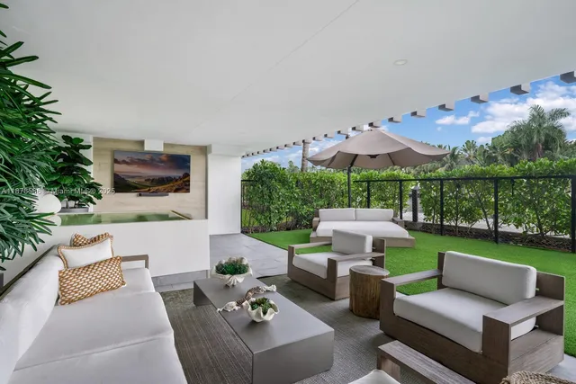 a view of a patio with couches table and chairs with potted plants