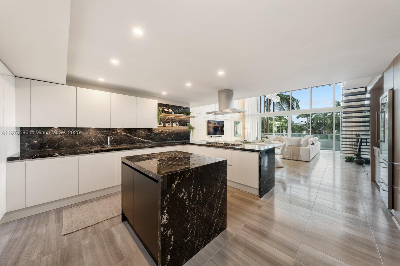 4701 Meridian Avenue, Unit 222 Miami Beach, FL 33140 - Photo 9 of 44 a kitchen with a stove a sink and a refrigerator
