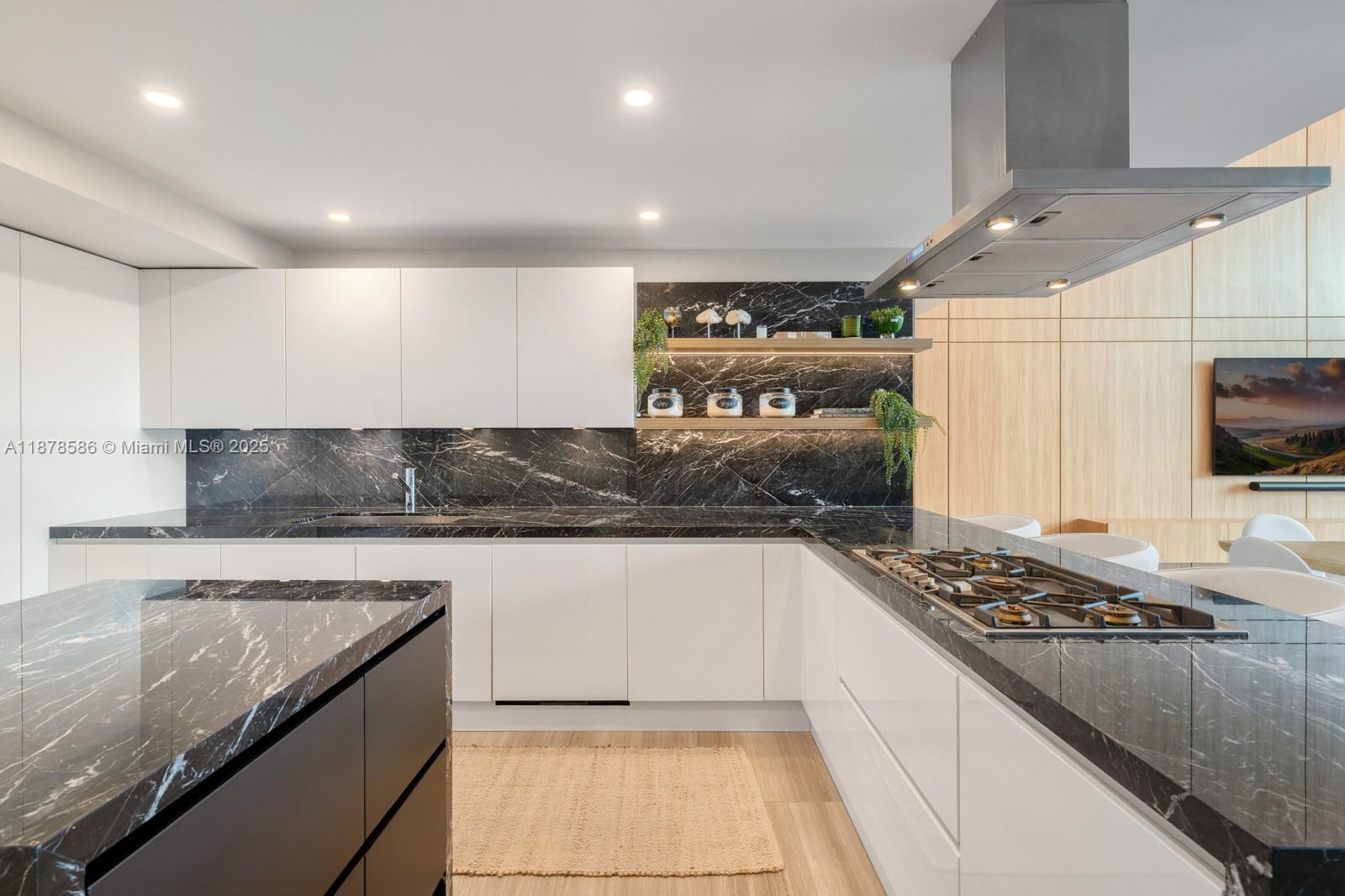 4701 Meridian Avenue, Unit 222 Miami Beach, FL 33140 - Photo 10 of 44 a kitchen with stainless steel appliances granite countertop a stove and a sink