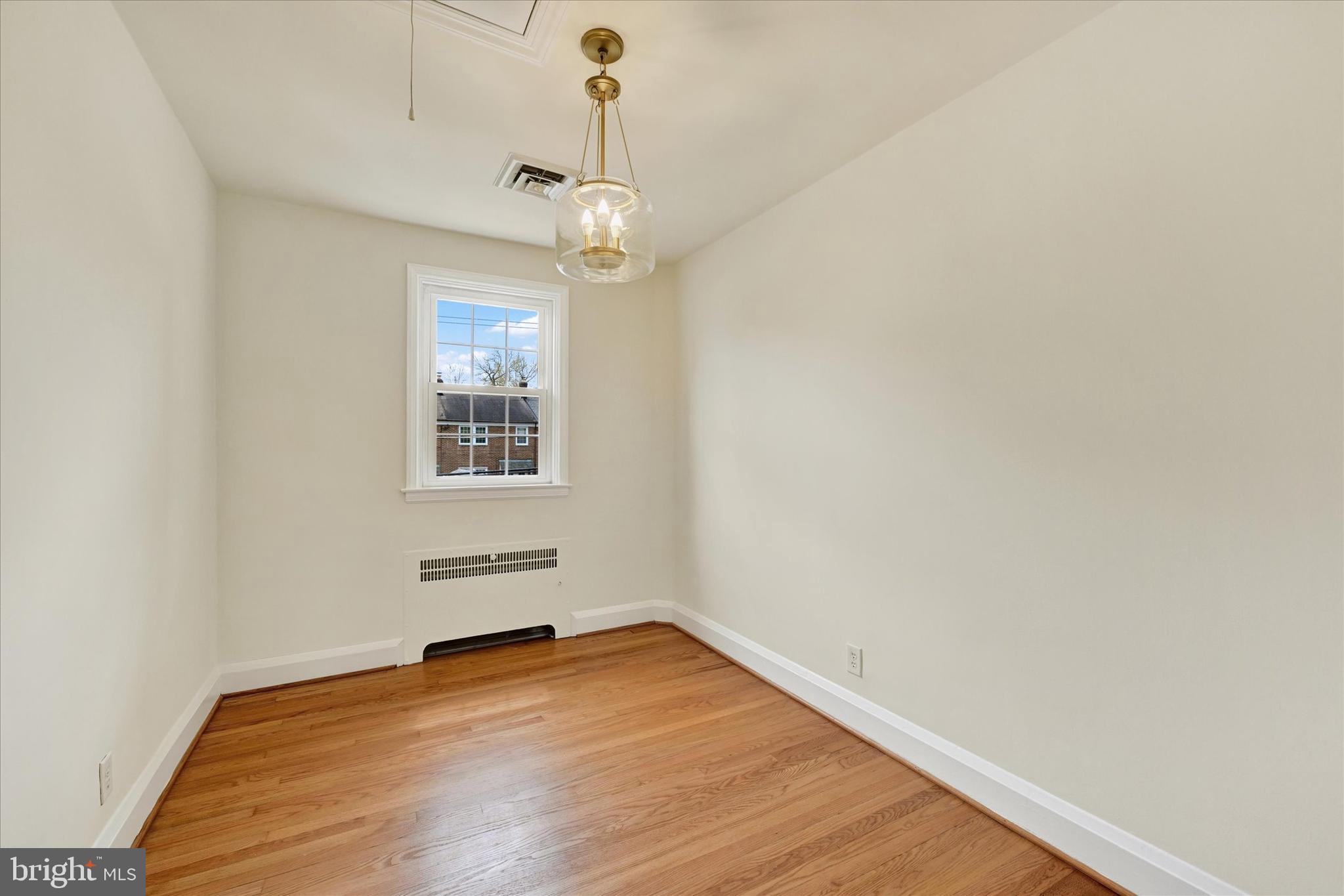 215 Regester Avenue Baltimore, MD 21212 - Photo 12 of 24 a view of empty room with wooden floor and fan