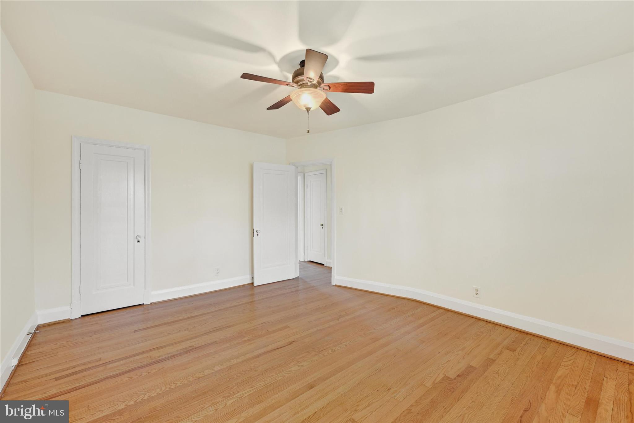 215 Regester Avenue Baltimore, MD 21212 - Photo 16 of 24 a view of a room with wooden floor and ceiling fan