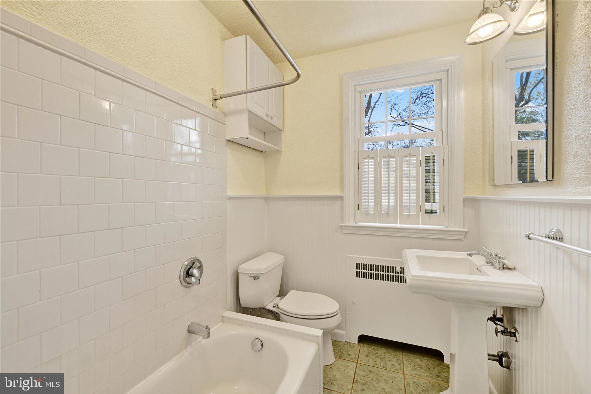 215 Regester Avenue Baltimore, MD 21212 - Photo 17 of 24 a bathroom with a sink toilet and shower