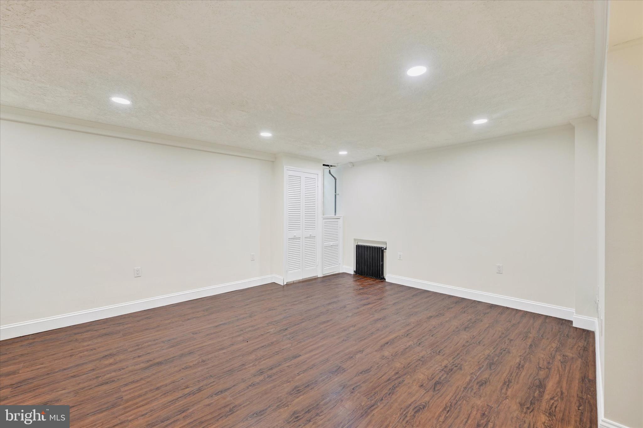 215 Regester Avenue Baltimore, MD 21212 - Photo 19 of 24 a view of an empty room with wooden floor