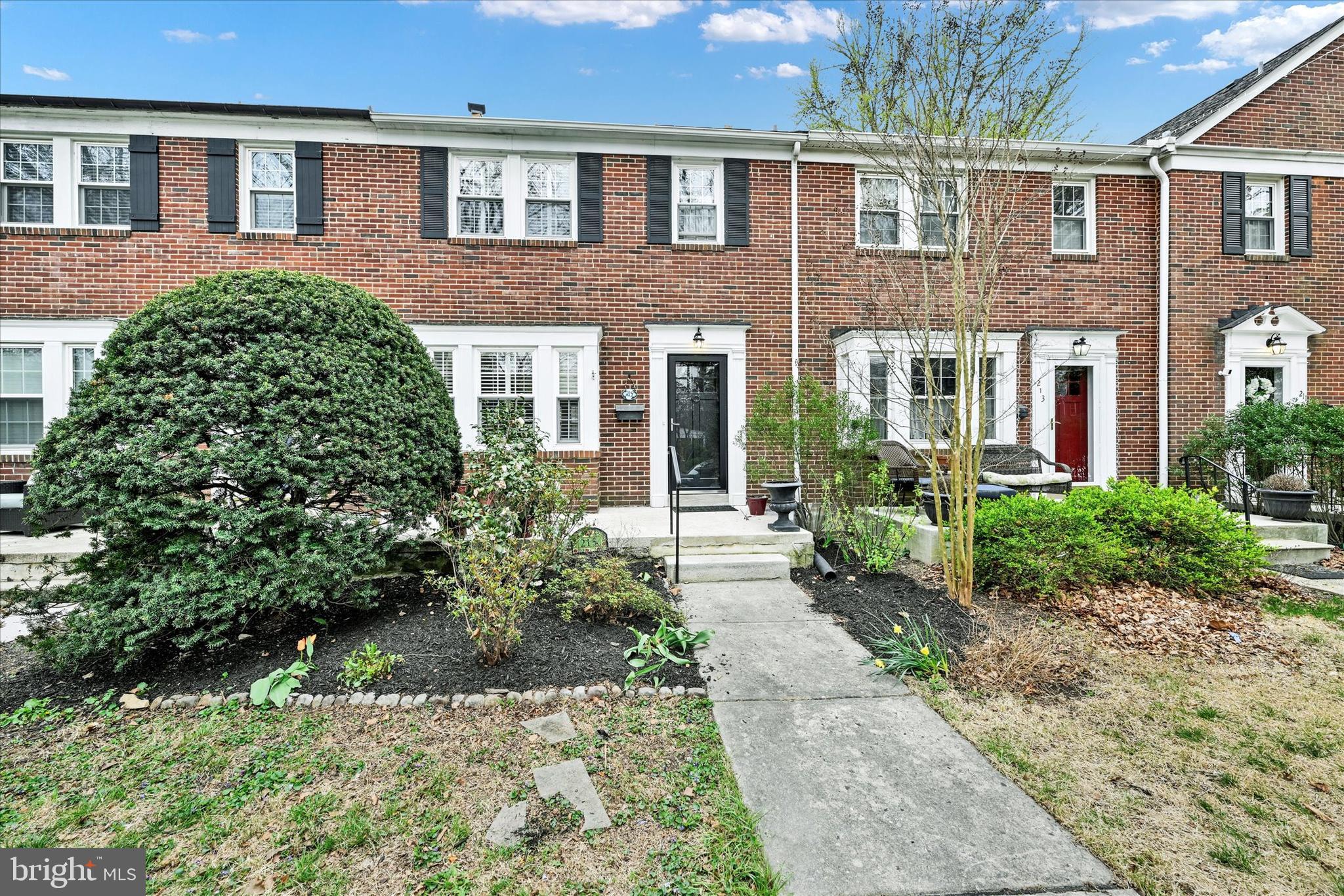 215 Regester Avenue Baltimore, MD 21212 - Photo 2 of 24 front view of a brick house with a yard