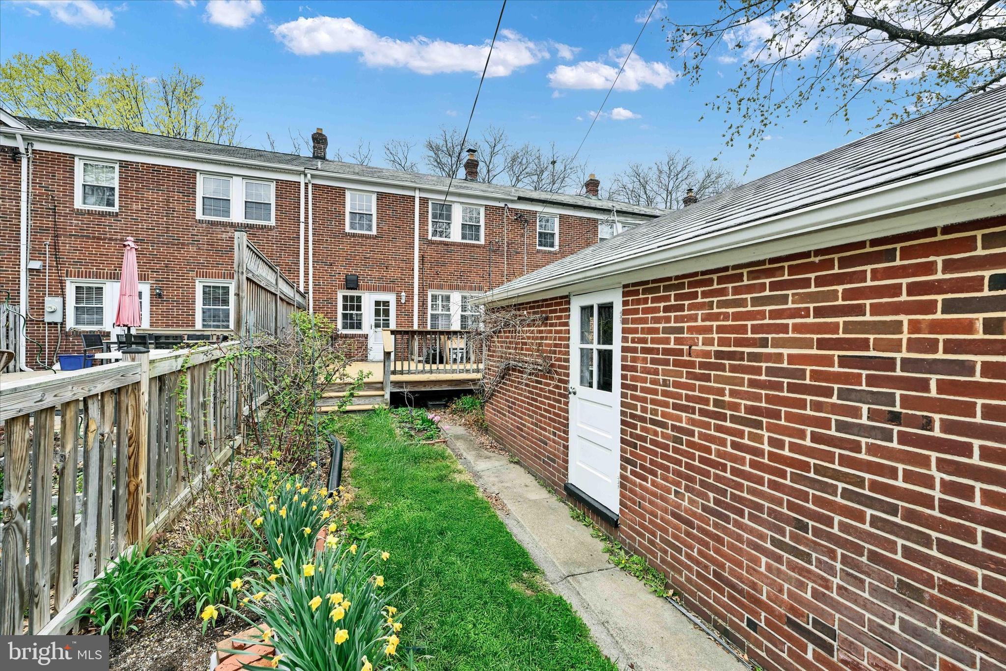 215 Regester Avenue Baltimore, MD 21212 - Photo 23 of 24 a view of a brick house with a yard and potted plants